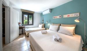a bedroom with a bed with two towels on it at ARISMARI Garden Apartment in Lygaria +27 photos