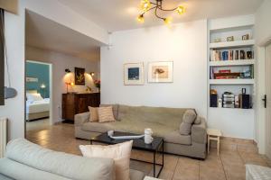 a living room with a couch and a table at ARISMARI Garden Apartment in Lygaria