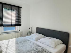 a bed with two pillows on it in a bedroom at Connect 9.3 in Dorum-Neufeld