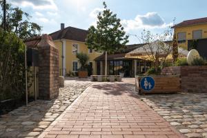 a house with a brick driveway in front of a building at HeindlHof in Ingolstadt