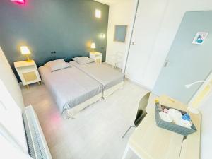 a bedroom with a bed and a table with a baby crib at Flatshare Colocation 4 close to Geneva in Saint-Genis-Pouilly