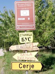 un letrero de la calle con diferentes letreros. en Sljivik, en Niš