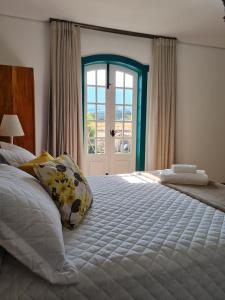 מיטה או מיטות בחדר ב-Pousada Candelabro