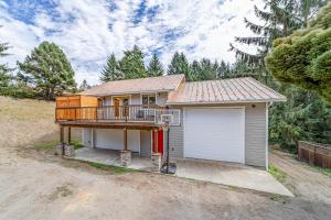 a house with a deck and a garage at The DoJo in Fortuna