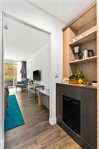 a kitchen and living room with a large mirror at Meerglück in Glücksburg