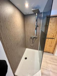 a shower with a glass door in a bathroom at Maison de ville Atypique - centre ville in Lannion