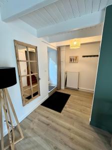 a living room with a window and a mirror at Maison de ville Atypique - centre ville in Lannion