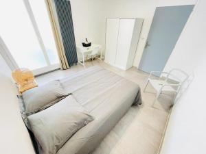a bedroom with a bed and a table and a chair at Flatshare 5 Colocation close to Geneva in Saint-Genis-Pouilly