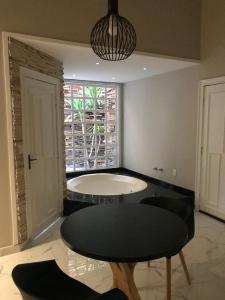 a dining room with a table and a window at Pousada e Motel Blue Inn in Cascavel