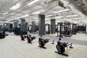 a gym with rows of exercise bikes and treadmills at Level Seattle Downtown - South Lake Union in Seattle