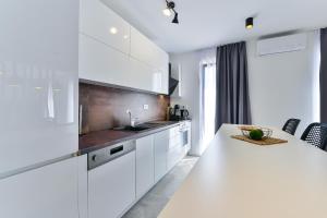 a white kitchen with a sink and a counter at Jean-Marie in Zaton