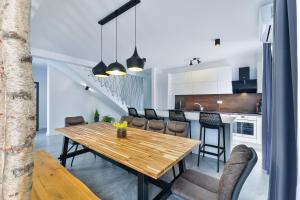 a kitchen and dining room with a wooden table and chairs at Jean-Marie in Zaton
