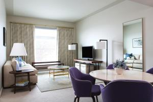 um quarto de hotel com uma mesa e cadeiras e uma sala de estar em 21c Museum Hotel Bentonville - MGallery em Bentonville