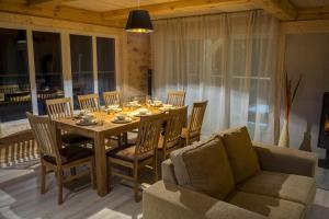 a dining room with a table and chairs and a couch at Hapsal Holiday Homes in Haapsalu