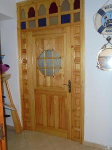 a wooden door with a window in a room at Seaside House in Imsouane