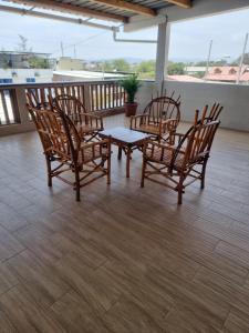 a group of chairs and a table on a balcony at CRUCITALIA Departamento x 8 in Crucita