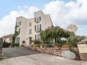 a white building with a sign in front of it at Alcombe House in Minehead