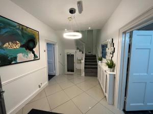 a hallway with a large painting on the wall at Alcombe House in Minehead