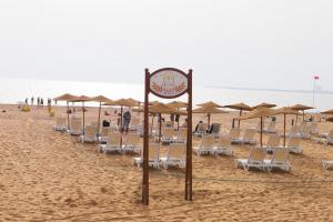 a group of chairs and umbrellas on a beach at Hotel Argana Agadir in Agadir