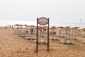 un grupo de sillas y sombrillas en una playa en Hotel Argana Agadir, en Agadir