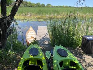 two kayaks on a dock next to a body of water at The Prince Edward County Church in Belleville