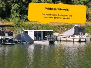 two boats are docked at a marina on the water at Moselcube in Traben-Trarbach