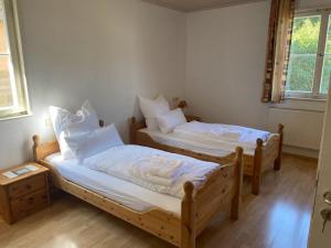 two twin beds in a room with two windows at Gasthaus Lamm in Waldenbuch