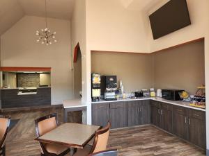 a dining room with a table and a kitchen at Days Inn by Wyndham Clemson in Clemson
