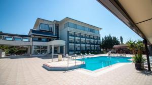 a large building with a swimming pool in front of it at Lake Life Hotel in İznik
