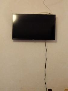 einen Flachbild-TV, der an einer Wand hängt in der Unterkunft Casa la Era in Salas Bajas