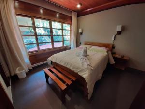 a bedroom with a large bed and a window at Hotel Heidinger in Oxapampa