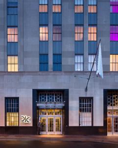 a man standing in front of a building at 21c Museum Hotel Durham in Durham