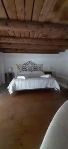 a bedroom with a bed with a wooden ceiling at Un loft solo per i tuoi occhi in Bergamo