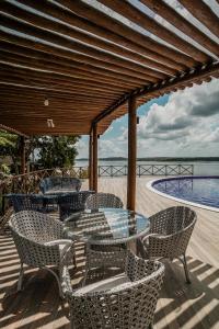 a patio with a table and chairs and a pool at Eco Resort Pedra Bonita in Santo Estêvão
