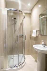 a bathroom with a shower and a sink at BOTANIC APARTMENT SLEEPS 6 in Belfast