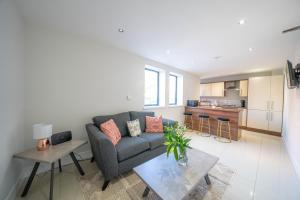 a living room with a couch and a table at BOTANIC APARTMENT SLEEPS 6 in Belfast