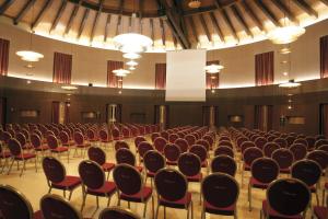 an empty auditorium with red chairs and lights at Marinagri Greenblu Hotel in Policoro +24 photos
