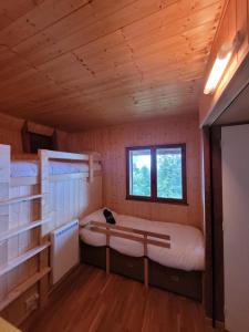a room with two bunk beds and a window at Chalet Chalon in Meillerie