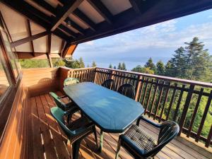 a wooden deck with a table and chairs on it at Chalet Chalon in Meillerie