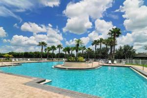 a pool at a resort with palm trees at Sandy Oasis 5 bedroom with Pool Sarasota Bradenton in Bradenton