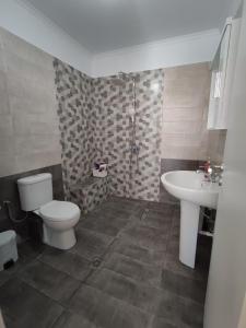 a bathroom with a toilet and a sink at kaite house in Kozani