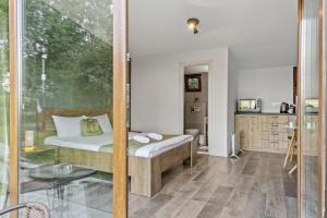 a bedroom with a bed and a glass door at Silver Bungalow in Săcele