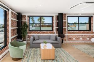 a living room with a couch and a brick wall at The Brick Boutique Hotel in Oceanside