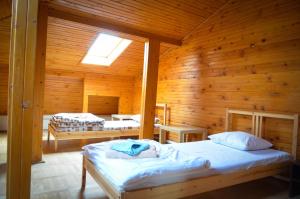 a bedroom with two beds in a wooden cabin at City Center Apartments & Suites by RDC in Bucharest