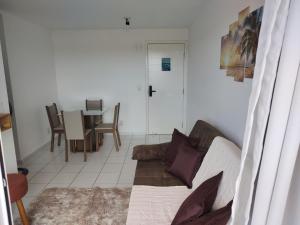 a living room with a couch and a table at Apartamento completo/ Verano Ponta Negra- Natal in Natal