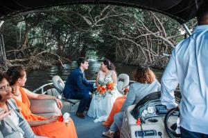 a bride and groom riding in a boat at Seaside Chateau Resort in Belize City