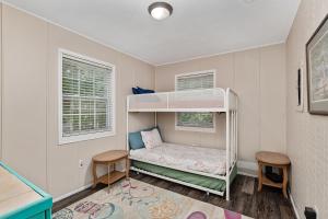 a childs bedroom with a bunk bed and two chairs at Family Forest Retreat, Paradise at Point Pleasant! 