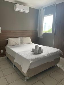 ein Schlafzimmer mit einem Bett mit zwei Handtüchern darauf in der Unterkunft Edifício Mariana Apto com 3 Quartos - Jatiúca in Maceió