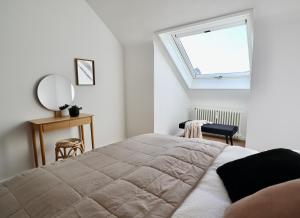 a bedroom with a large bed and a window at Wohntraeumerei Bergblick- Ihr privates Hideaway in Bad Berleburg, einem Wanderparadies in Bad Berleburg