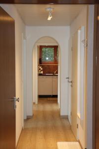 an empty hallway with a kitchen in a house at Waldblick in Baiersbronn